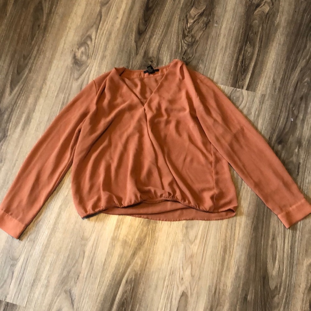 Cute orange ish reddish top. Recommend to wear a tank top under.